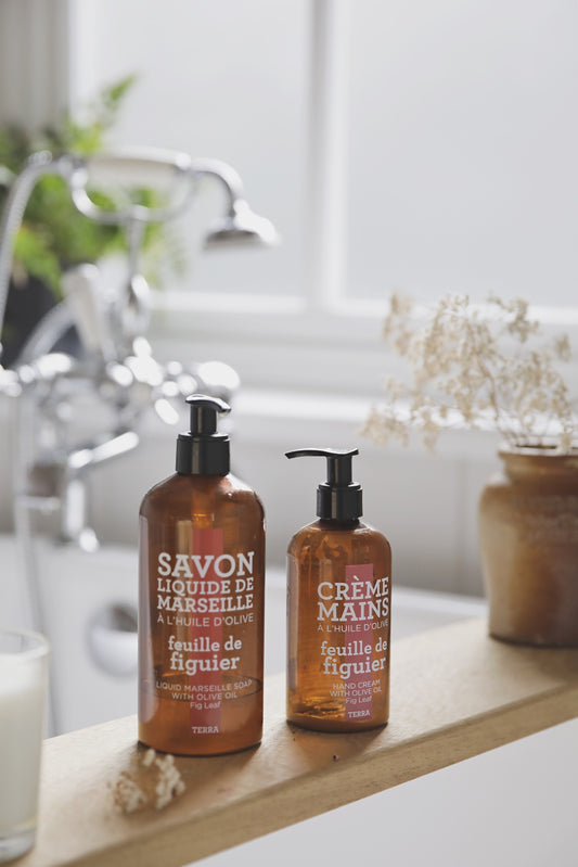 Compagnie de Provence Terra Fig Leaf liquid soap and hand cream on a bath board