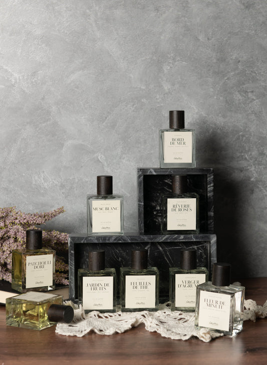 Lothantique White Musk eau de parfum with other perfumes on marble stands