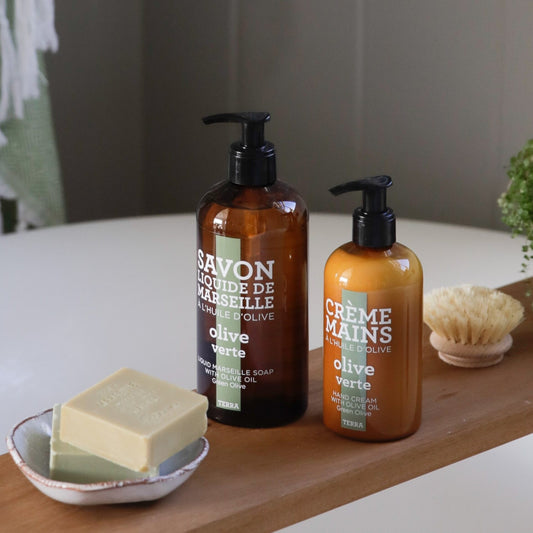 Compagnie de Provence Terra Green Olive liquid soap and hand cream on a bath board