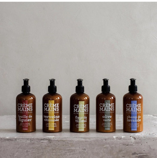 Five Compagnie de Provence Terra hand creams standing on concrete