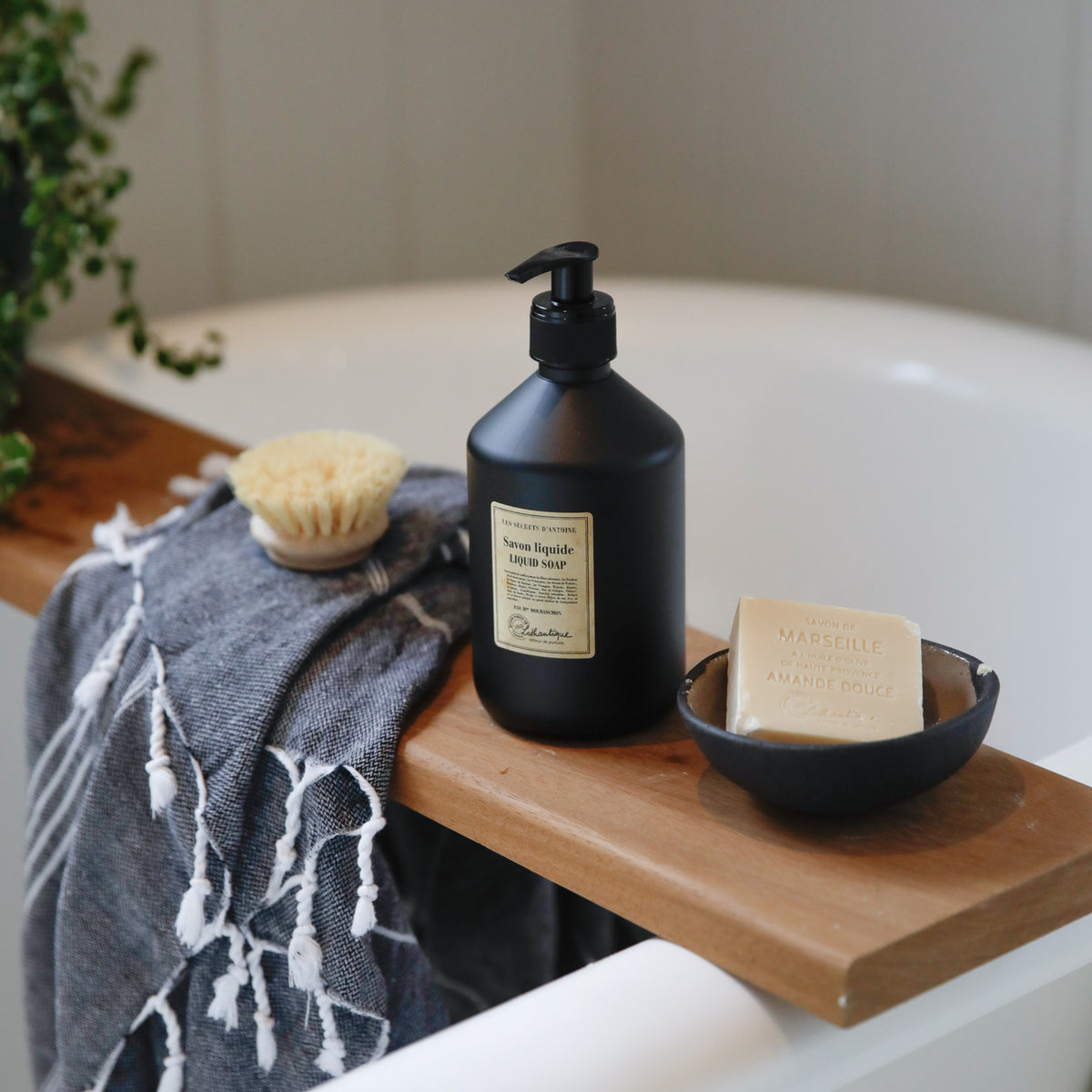 Lothantique Les Secrets d'Antoine liquid soap and soap bar on a bath board
